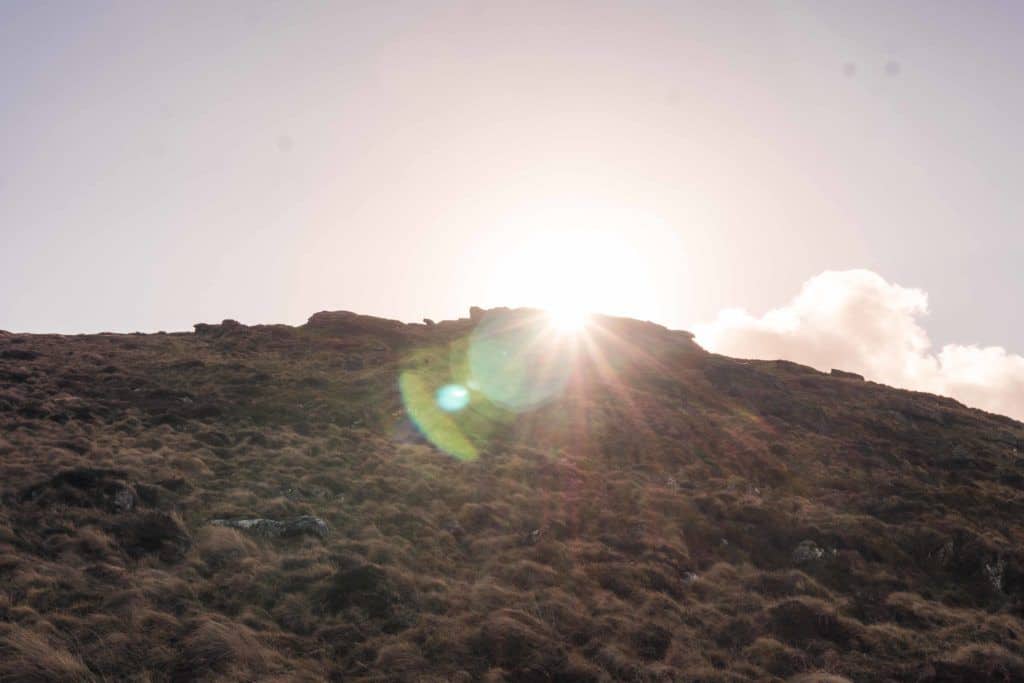 Hiking Rippon Tor, near Haytor, Dartmoor Walks, Devon, England: sunset at the trig point