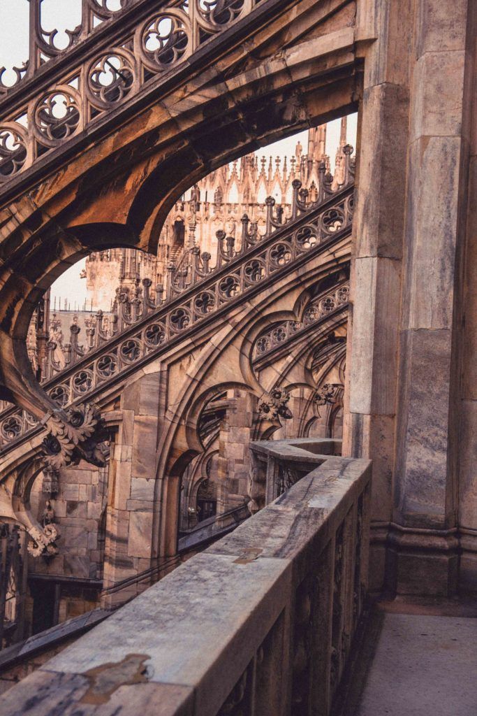 Rooftop terrace and intricate carving, empty at sunset on the Duomo di Milano terraces