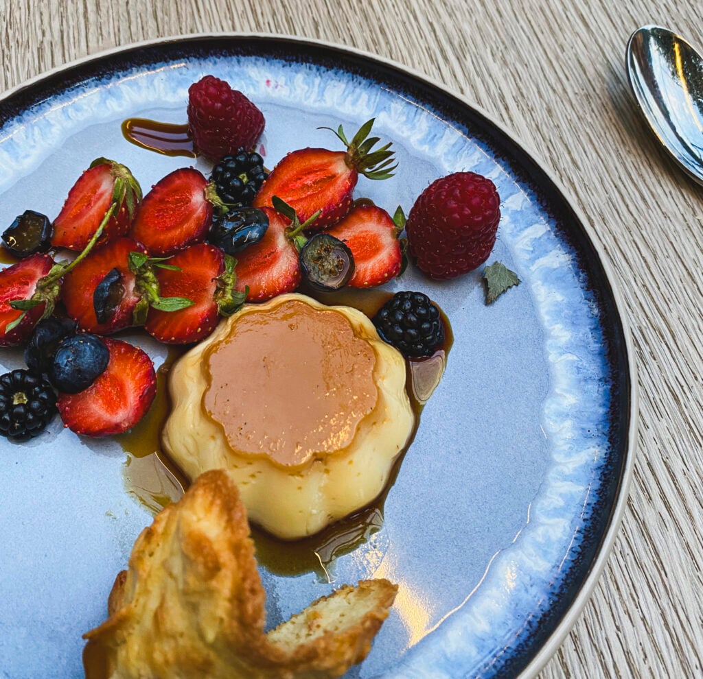 creme caramel and fruit on a plate, french dessert