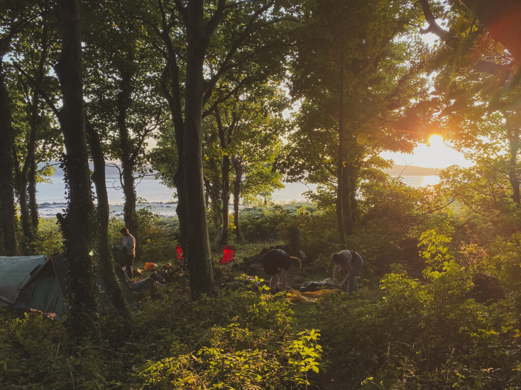 setting up camp in the forest on cramond island, scotland