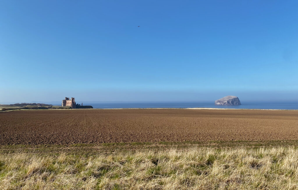 view of bass rock and north berwick castle in the distance