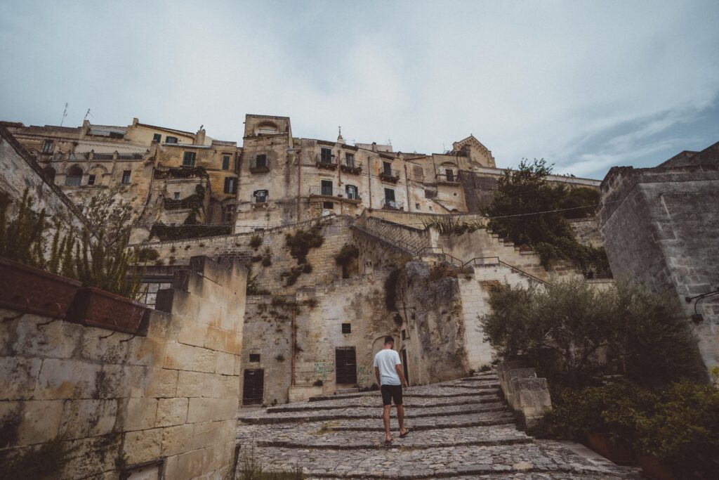 person walking up the stairs in matero italy