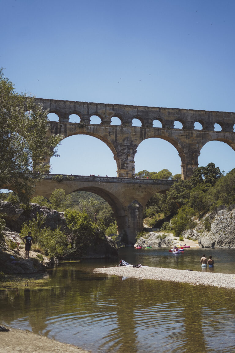 pont du gard and people swimming in the river