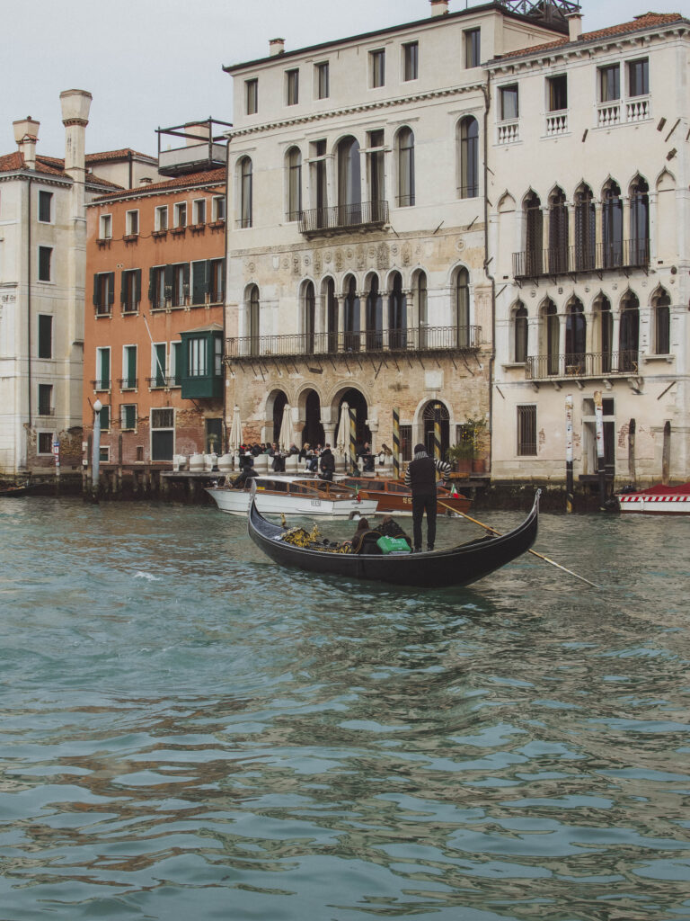 man rowing Gondala in waterways of Venice