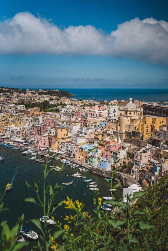 view of pastel coloured houses and shoreline in Procida